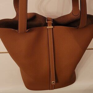 Brown leather w/ suede interior shoulder fashion bag. Bucket style.  No brand